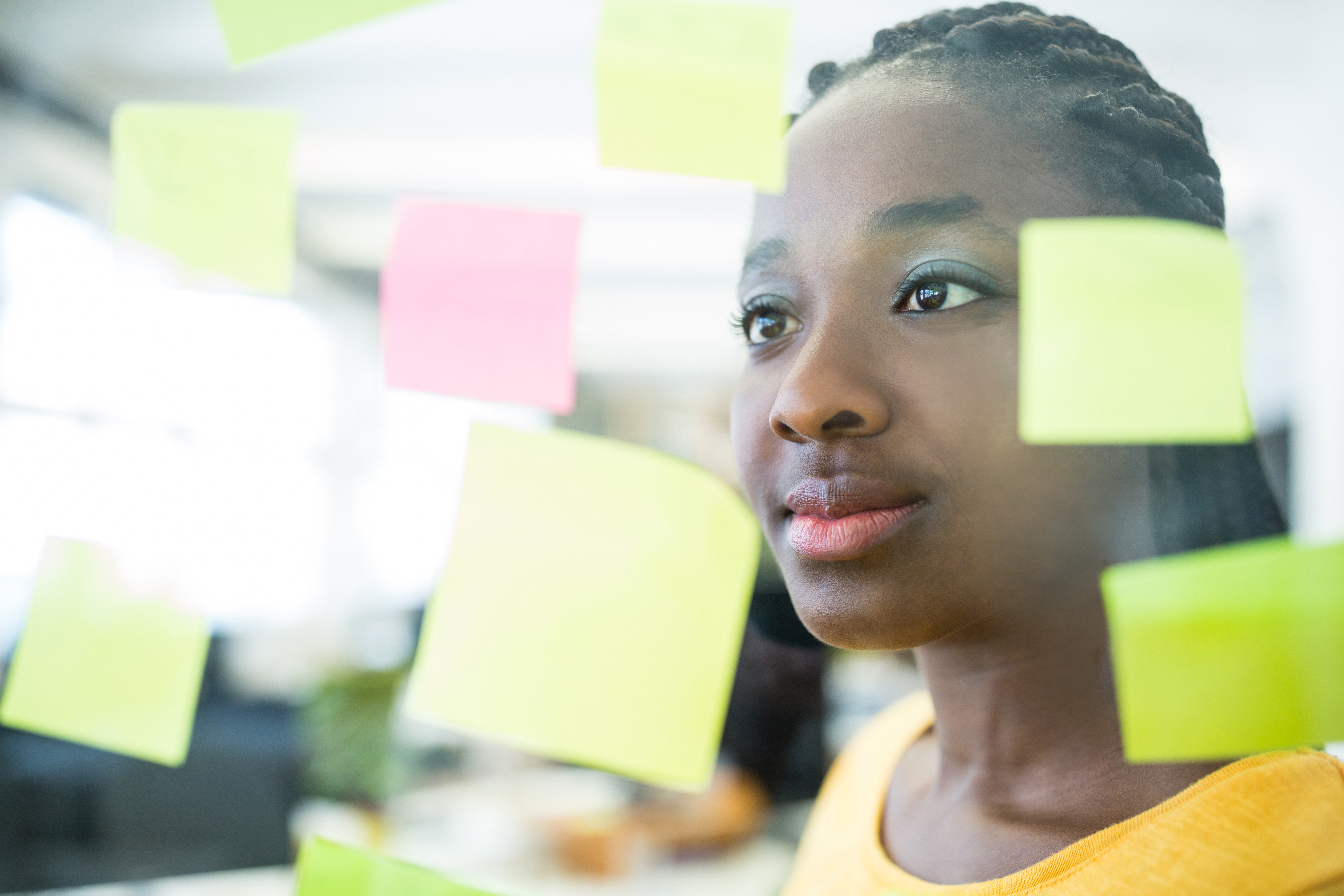 female-graphic-designer-looking-sticky-notes.jpg 